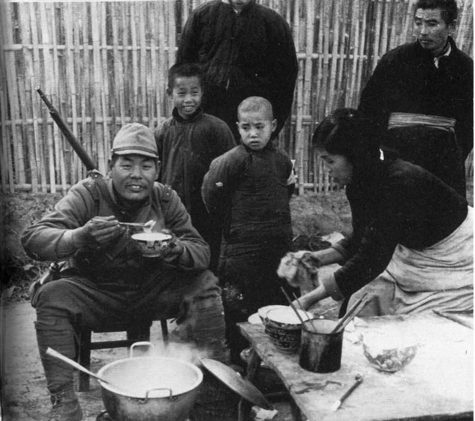 15th Dec 1937, Nanking Safty Zone. Photo By Shinjyu Sato, Tokyo Nichi-Nichi News Paper Photographer. Japanese Army Soldier eating the Nudle, paid the money.